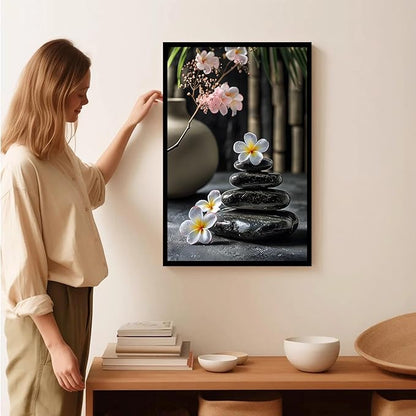 A harmonious black stone stack paired with white and pink flowers bamboo and ceramic vases creates a tranquil Zen decor for minimalist homes and mindful spaces 24x36in Metal blackFramed